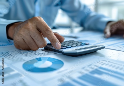 "Calculating Financial Success: Businessman Analyzing Data with Coins on Table"