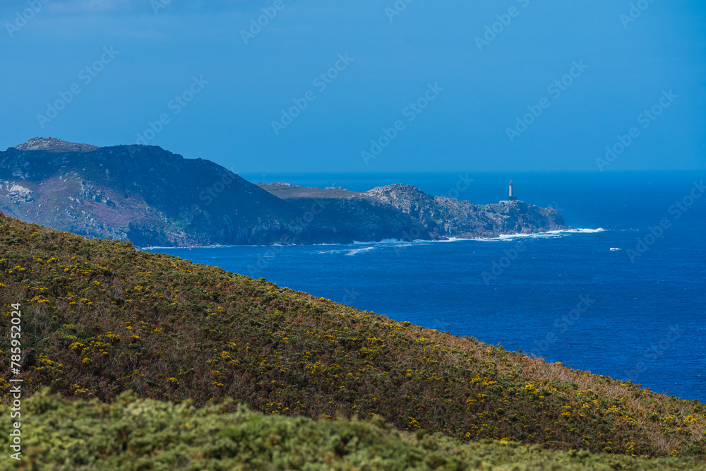 View of a lighthouse on top of headland on the Atlantic Ocean coast. Punta Nariga, Costa Da Morte, Galicia, Spain