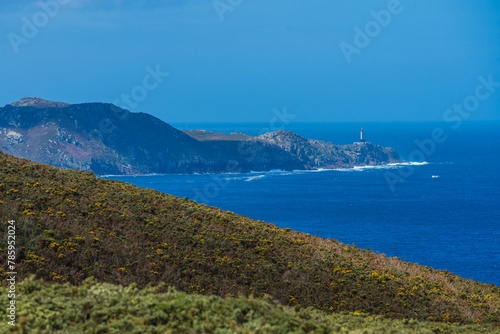 View of a lighthouse on top of headland on the Atlantic Ocean coast. Punta Nariga, Costa Da Morte, Galicia, Spain