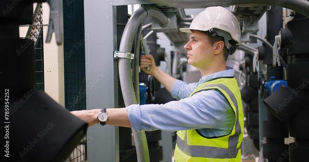 Civil engineer manager checking industry cooling air conditioner water cooling tower air chiller of large industrial building to control air system at construction site Civil engineer manager checking industry cooling air conditioner water cooling tower air chiller of large industrial building to control air system at construction site