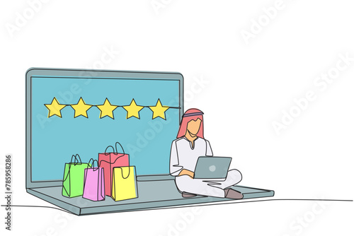 Single one line drawing happy Arabian man sitting on giant laptop typing on laptop. Bought a lot from online shop. Give a review of 5 stars. Ecommerce. Continuous line design graphic illustration