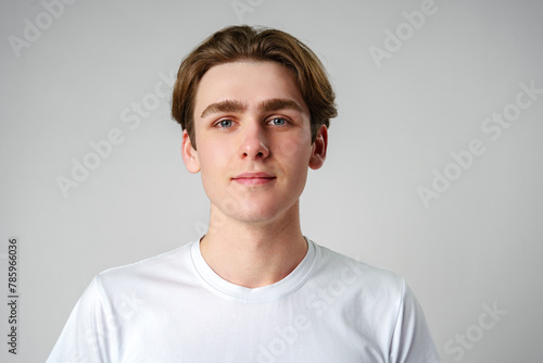 Young Man in White Shirt Looking at Camera