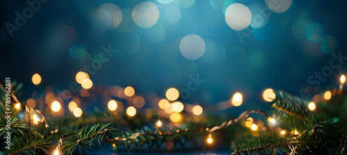 holiday illumination and decoration concept - christmas garland bokeh lights over dark blue background