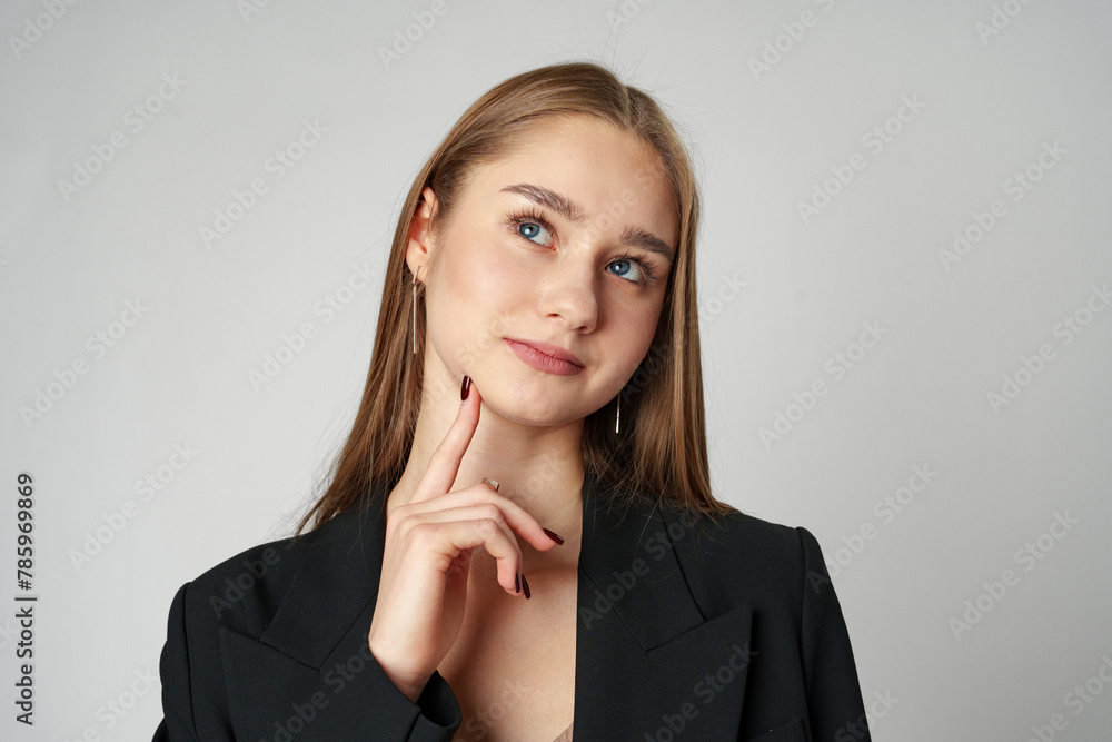 Thoughtful Young Woman Posing iAgainst a Plain Background Thoughtful Young Woman Posing iAgainst a Plain Background