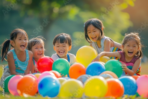 Asian children laughing and playing with vibrant balloons celebrating Children's Day or birthday party