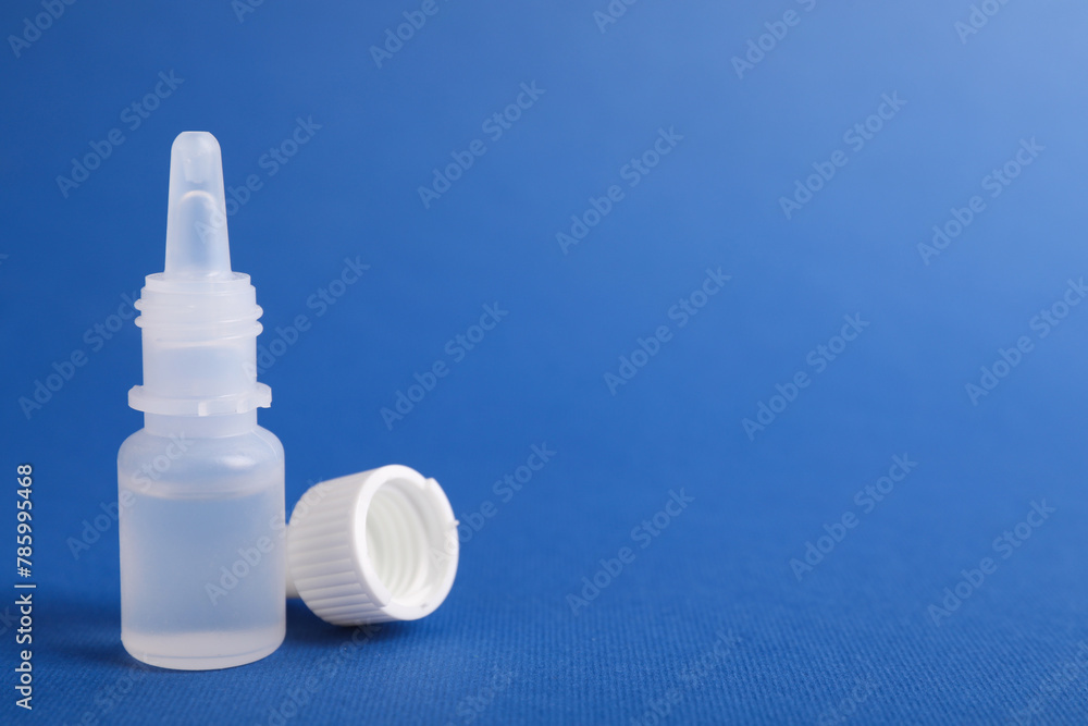 Bottle of medical drops on blue background, space for text Bottle of medical drops on blue background, space for text