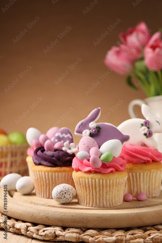 Tasty cupcakes with Easter decor on table