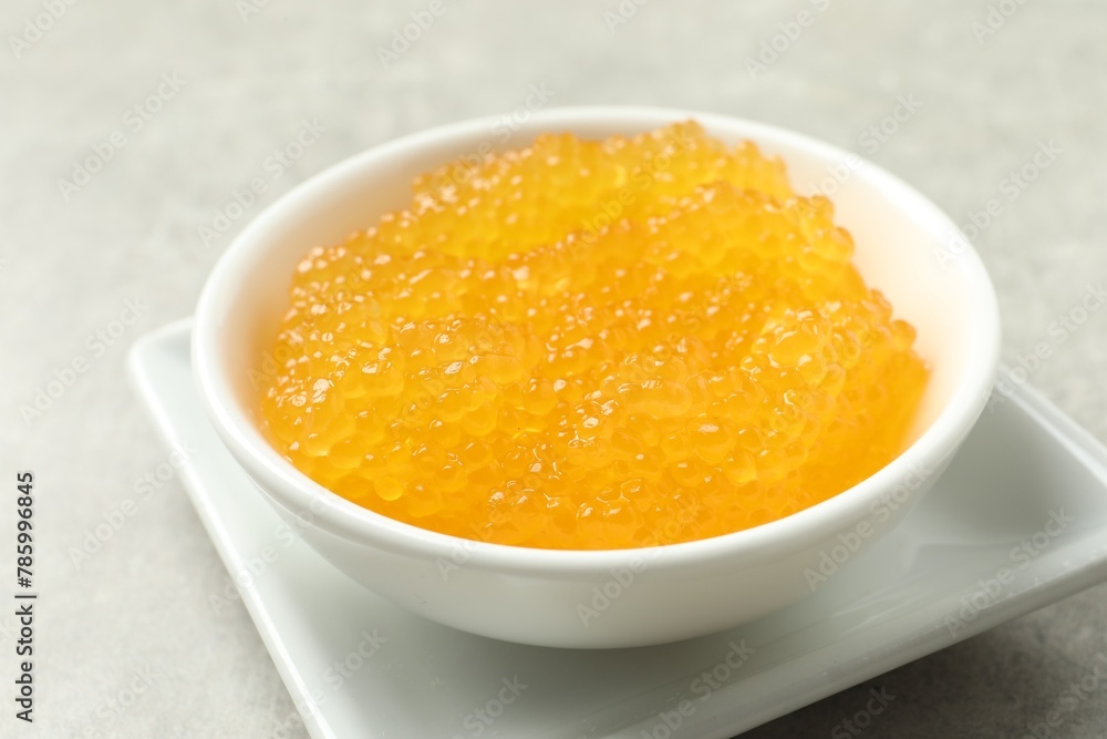 Fresh pike caviar in bowl on light grey table, closeup Fresh pike caviar in bowl on light grey table, closeup
