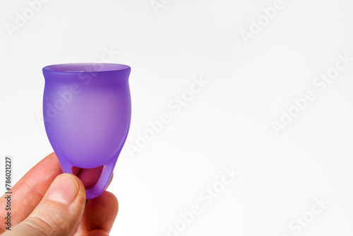 Woman's Hands Holding Purple Menstrual Cup: Copy Space on White Background
