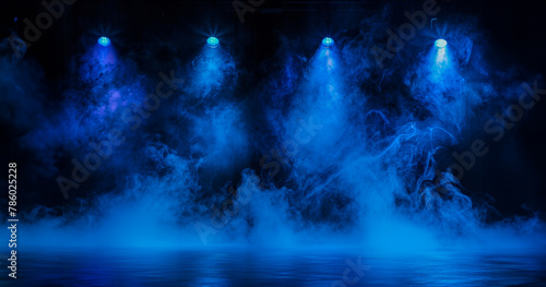 A stage with four blue lights and a foggy mist