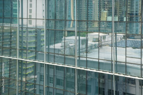 Texture from the windows of modern skyscraper and reflections of other buildings.