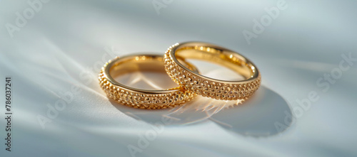 Two gold rings with a diamond pattern on them