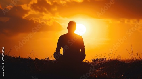 A thought provoking photograph of a man sitting in front of the sun creating a touching silhouette Ideal for projects delving into self reflection and mindfulness © 2rogan