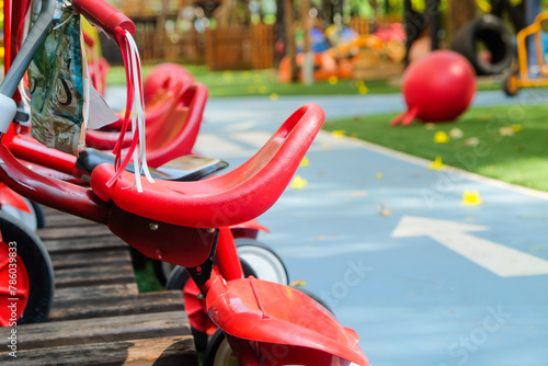 Red tricycle in the park, children's playground in the park