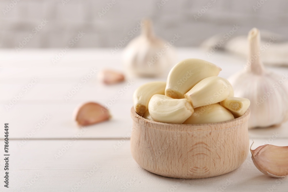 Fresh garlic on white wooden table, closeup. Space for text Fresh garlic on white wooden table, closeup. Space for text