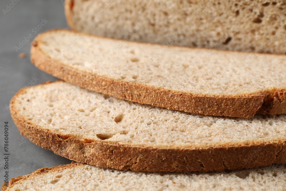 Freshly baked cut sourdough bread on grey table, closeup Freshly baked cut sourdough bread on grey table, closeup