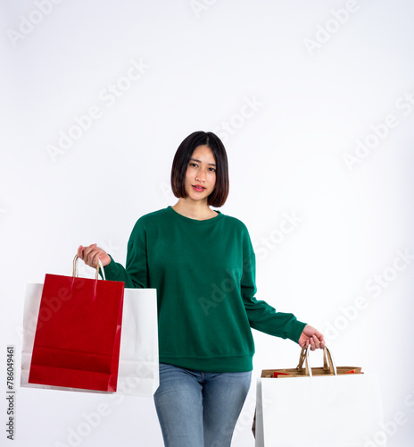 Young woman asian wearing green shirt of smiling face in shopping solated on white background, she is smiling lifesty and looking at camera, portrait young woman shopping, lifestyle concept.