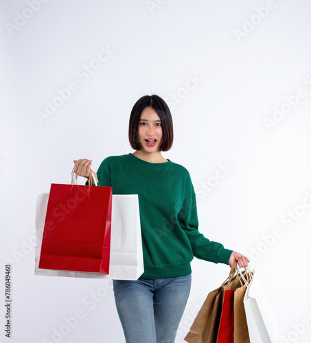 Young woman asian wearing green shirt of smiling face in shopping solated on white background, she is smiling lifesty and looking at camera, portrait young woman shopping, lifestyle concept.