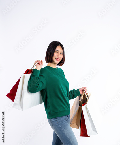 Young woman asian wearing green shirt of smiling face in shopping solated on white background, she is smiling lifesty and looking at camera, portrait young woman shopping, lifestyle concept.