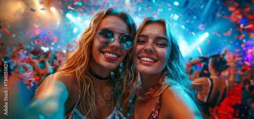 Two women are smiling and posing for a picture at a party