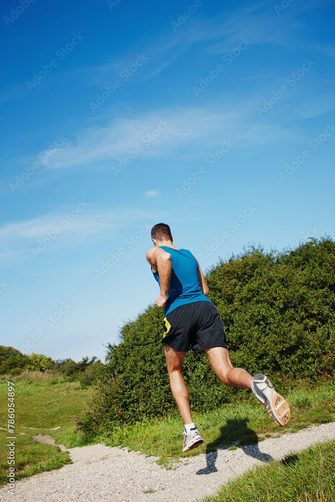 Man, fit and running in outdoor for fitness, health and wellness in nature for workout or exercise. Male athlete, training and cardio with endurance, muscles and strength for healthy living or gym Man, fit and running in outdoor for fitness, health and wellness in nature for workout or exercise. Male athlete, training and cardio with endurance, muscles and strength for healthy living or gym
