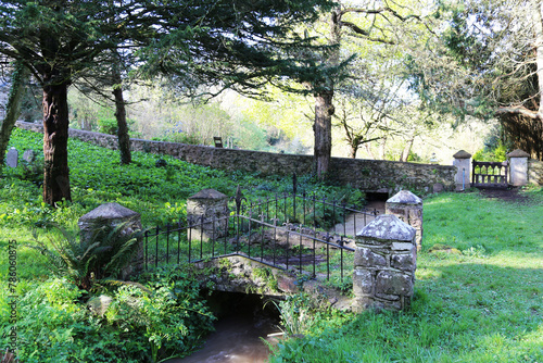 A quaint little bridge across a small stream at St Ishmael churchyard in Pembrokeshire, Wales, UK.