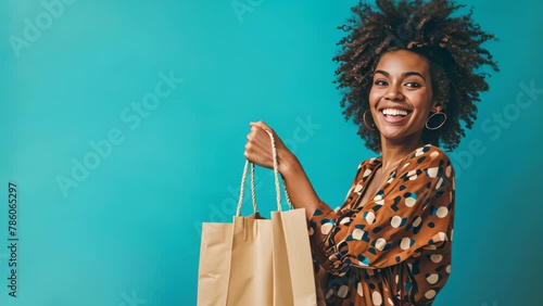 Protrait of young woman carry shopping bag on blue background. photo