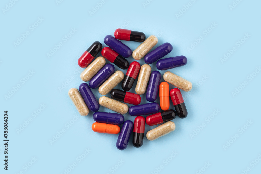 Heap of colorful medicine pills on blue background Heap of colorful medicine pills on blue background