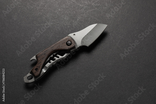 tactical folding knife. EDC knife. on dark background