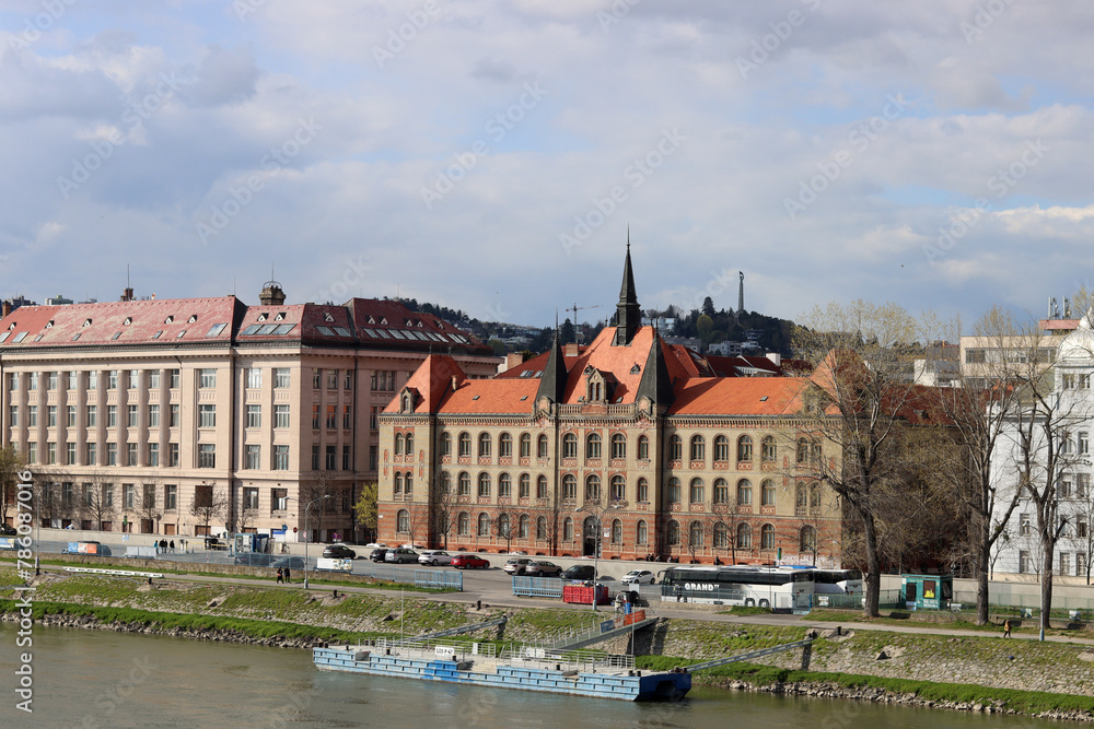 Fototapeta premium Architecture of Bratislava, Slovakia. View on old town from Danube river. Cloudy spring day. Panoramic photo of beautiful old buildings. Tourist destinations concept. 