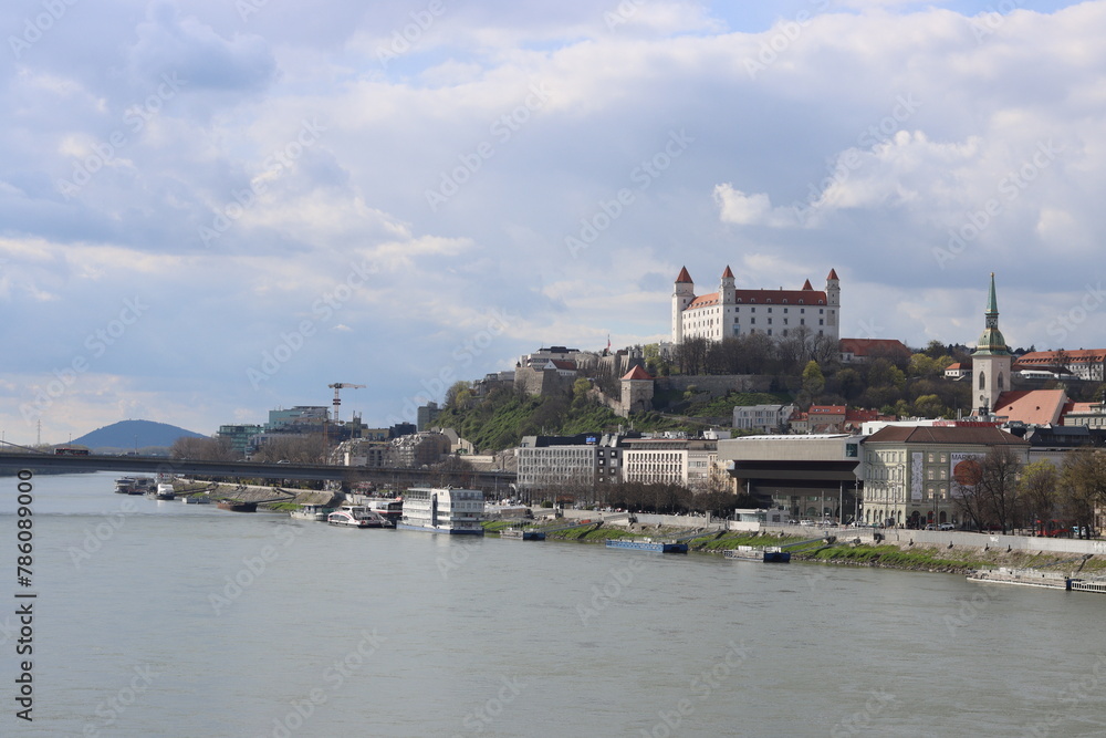 Bratislava old town panoramic view from Danube river. Bratislava castle on cloudy day. European architecture concept. 