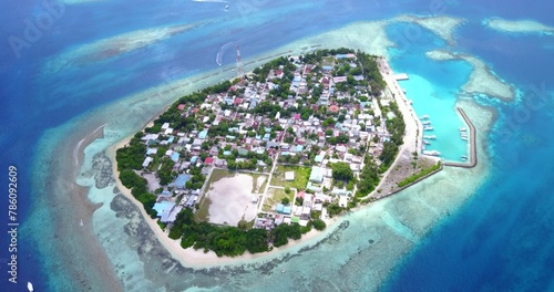 Aerial view of a city on an island in the middle of the blue calm sea on a sunny day