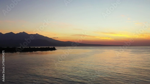 Beautiful view of an island with a calm sea during sunset