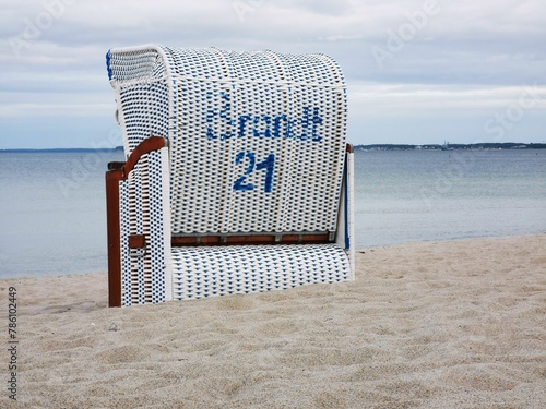 Beach chair on the sand by the sea with the number 21 photo