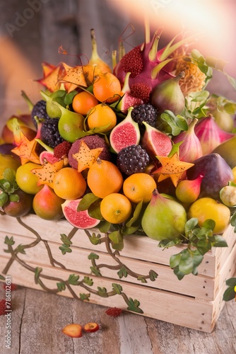 Exotic fruits in a crate with kumquats and figs