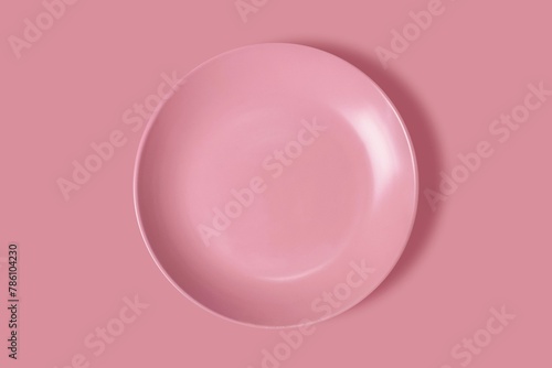 3D rendering of a pink ceramic plate isolated on a pink background