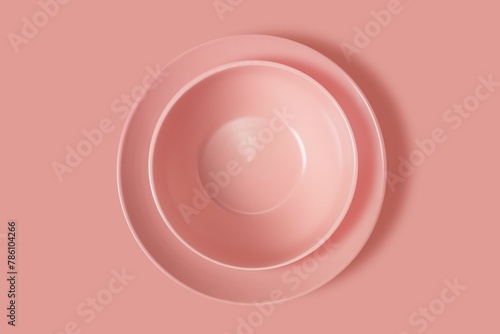 3D rendering of two pink ceramic plates isolated on a pink surface