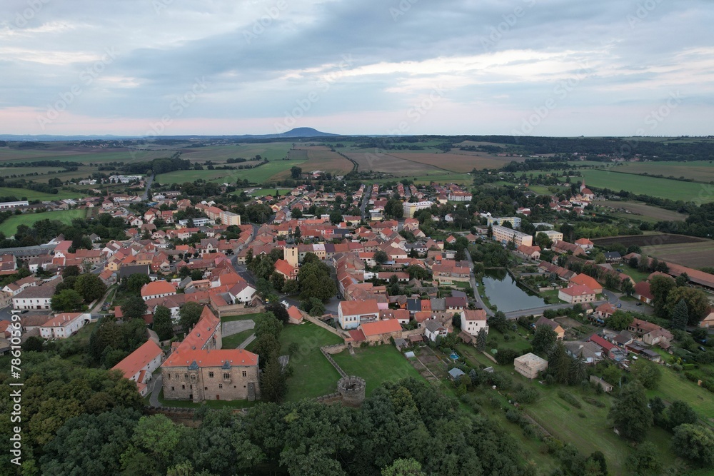 Beautiful aerial view of the medieval castle in Budyne nad Ohri surrounded by trees in Czechia Beautiful aerial view of the medieval castle in Budyne nad Ohri surrounded by trees in Czechia