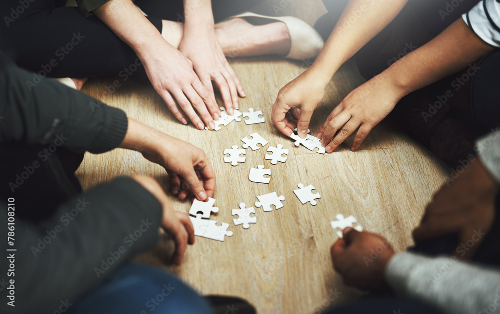 People, support and hands with puzzle on table for problem solving, interaction and teamwork in integration. Diversity, team and training with jigsaw for creative strategy, collaboration and learning People, support and hands with puzzle on table for problem solving, interaction and teamwork in integration. Diversity, team and training with jigsaw for creative strategy, collaboration and learning