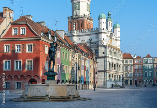 The colorful facades of the historic old town of Poznan are richly decorated and glow in the morning sun. Fountains decorate the main square.
