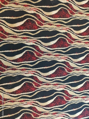 The red and black wavy pattern of the carpet