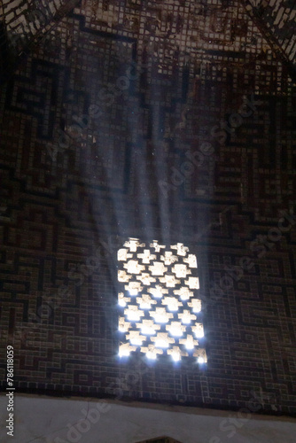 The old architecture and the shape of the windows that bring light into the traditional market of Isfahan