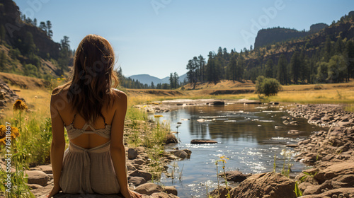 A nice fishing spot by the river, gentle breeze, and a beautiful woman in a sundress photo