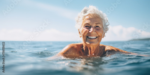Elderly woman enjoying the water with copy space © britaseifert