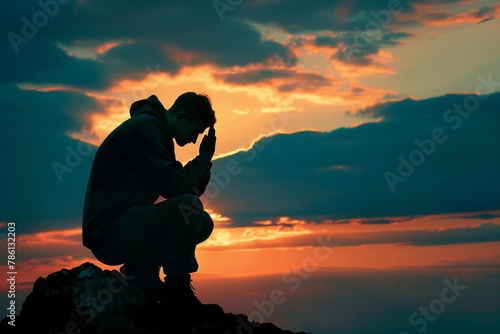 Silhouette of thankful man seeking god's praise and praising