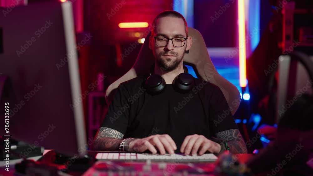 Man gamer playing virtual video games. Gamer designer sitting at computer monitor and nervously playing virtual online video game winner expression at home. Internet gambling addiction concept. Man gamer playing virtual video games. Gamer designer sitting at computer monitor and nervously playing virtual online video game winner expression at home. Internet gambling addiction concept.