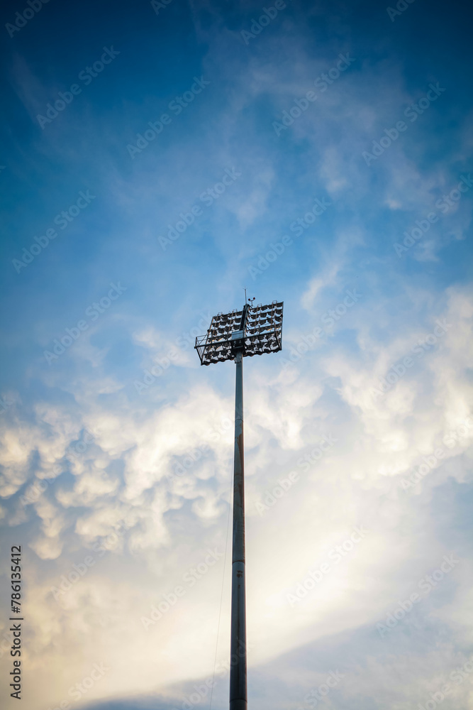 Stadium lights isolated on blue sky and clouds. Stadium lights isolated on blue sky and clouds.