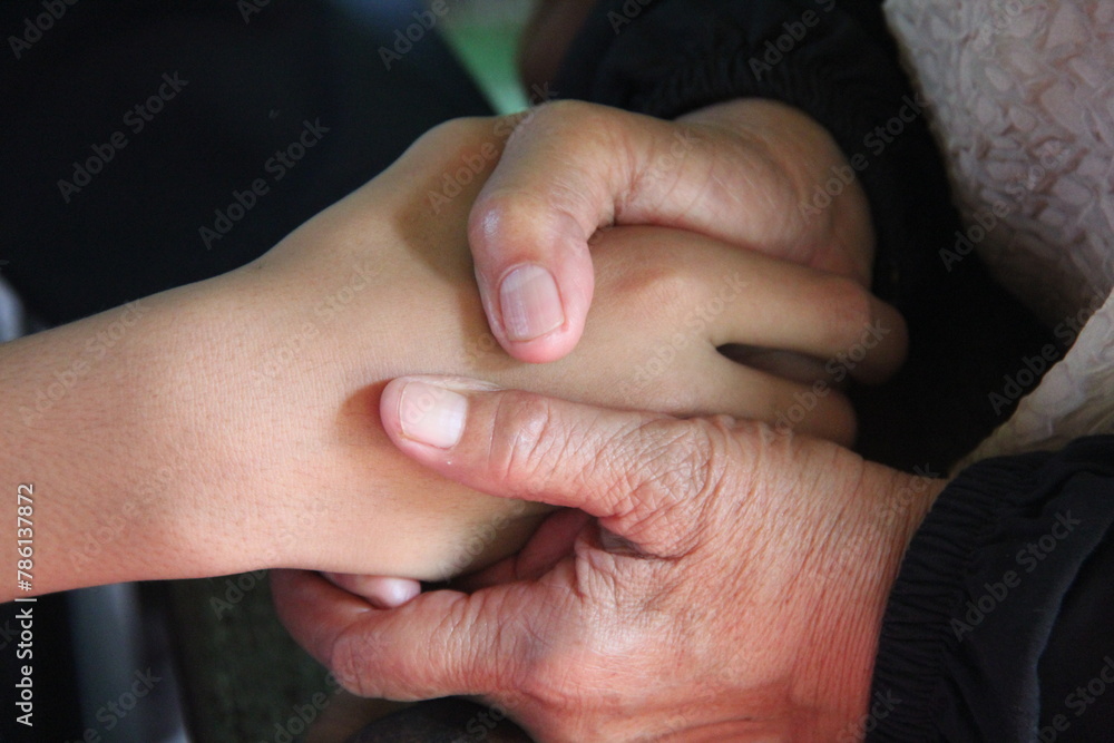 Close up of a person holding their hands Close up of a person holding their hands
