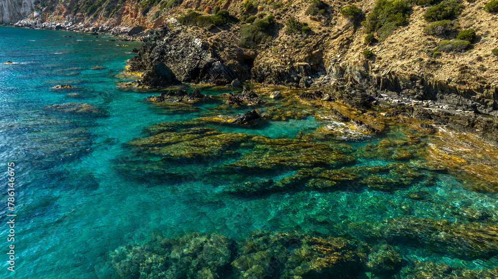 Aerial view on the rocks in the crystal clear sea of southern Sardinia, Italy. The sea is clean with colors ranging from blue to turquoise.