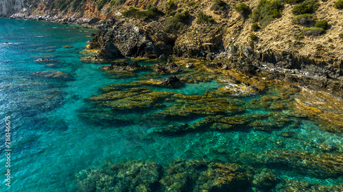 Aerial view on the rocks in the crystal clear sea of southern Sardinia, Italy. The sea is clean with colors ranging from blue to turquoise.